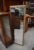 A bevel edged long framed hall or dress mirror