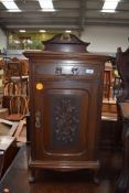 A late 19th/early 20th Century maghogany pot cupboard having poker work and applique decoration to