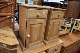 A pair of modern pine bedside cabinets