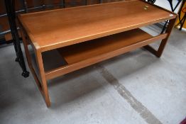 A mid century teak wood coffee table in a G plan style having under shelf