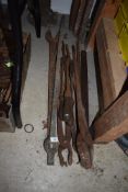 A selection of blacksmiths metal working tongs and similar large spanner etc