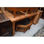 A natural pine kitchen dining table, on chunky square legs