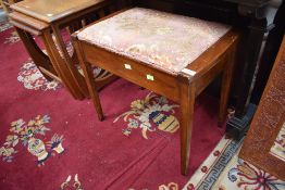 A traditional stained frame piano stool
