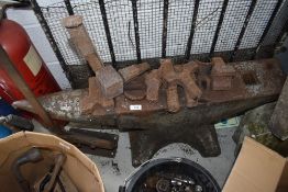 A large blacksmith or metal workers anvil having accessories and plate cutter included