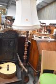 An early 20th Century mahogany standard lamp having turned base and column