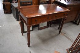 A Victorian mahogany side table having dual frieze drawers, on turned legs