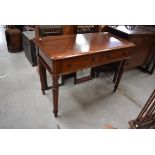 A Victorian mahogany side table having dual frieze drawers, on turned legs