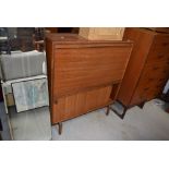 A vintage teak bureau with bookcase under having fall flap and sliding doors, width approx. 92cm