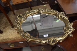 A gilt effect framed hallway mirror