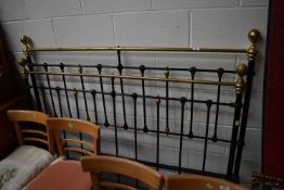 An antique cast iron and brass railed bed frame