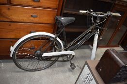 A vintage Velto Colt ladies bicycle with bell and basket