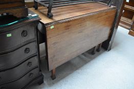 An antique drop leaf kitchen or dining table