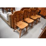 A set of four solid seat golden oak traditional style kitchen chairs, stamped 1998
