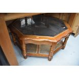 A modern glass top coffee table of octagonal form, shaped top and canework undertier, width