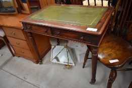 A Victorian mahogany desk having later skiver top, frieze drawers, with dummy drawers on reverse, on