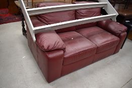 A Red leatherette settee , labelled Tesco (every little helps!)