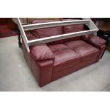 A Red leatherette settee , labelled Tesco (every little helps!)