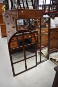 Two window pane style mirrors, arched and rectangular