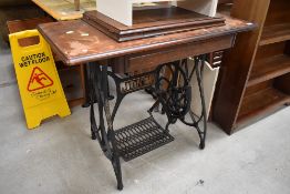 A Victorian sewing table housing a Jones Family treadle driven machine