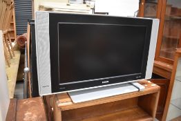 A Phillips HD flat screen television set with remote 26 inch, and a DVD player