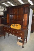 A Period oak dresser, having delft rack over two drawer base on Queen Anne style cabriole legs
