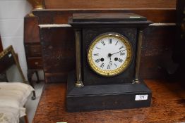 A gothic style Victorian mantle clock having enamel face dial