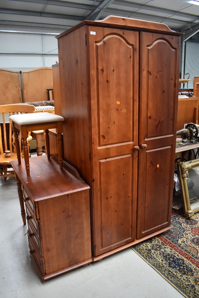 A modern pine wardrobe and dressing table with stool, reddish stain