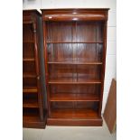 An Oriental hardwood bookcase having concealed upper drawer