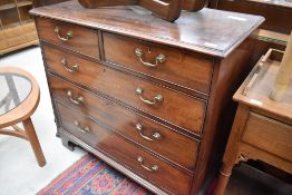 A 19th Century mahogany chest of two over three drawers having brass drop handles and scroll bracket