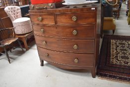 A 19th Century mahogany bow fronted chest of two over three drawers having brass rosette handles