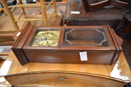 A reproduction mahogany effect wall clock , having brass Metamec face