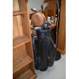 A selection of golf clubs including King Cobra and Daiwa, with bag and balls