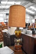 A mid century French styled lamp having coffee grinder base and original shade