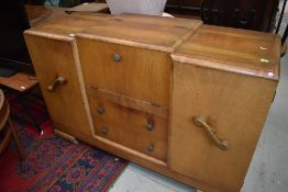 A 1950s walnut cocktail sideboard, similar to beautility