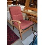 A vintage stripped frame armchair , later upholstery