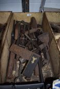 A selection of various hand tools including hide scrapers and set square