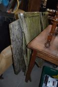 A teak garden table and pair of folding chairs, in need of some restoration