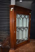 A Victorian mahogany cased corner wall unit having leaded light door and H hinges