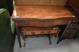 An antique fold out tea or similar table having solid mahogany tops