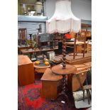 An early 20th Century mahogany standard lamp with integral side table, twist column and triple splay