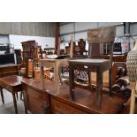 A pair of rustic oak chairs having leather seats and bent ply backs, possibly from railway waiting