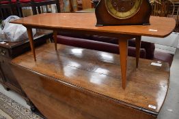 A vintage golden oak coffee table of stylised design, length approx. 127cm