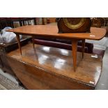 A vintage golden oak coffee table of stylised design, length approx. 127cm