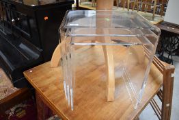 A nest set of modernist clear perspex occasional tables