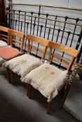 A set of four pine ladder back dining or kitchen chairs