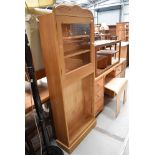 A natural pine bookcase having glazed top and open shelves under