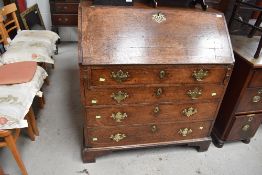 An antique chest and bureau having oak carcass and graduated set of four drawers