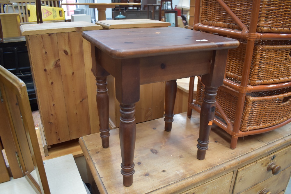 A dark stained pine occasional table