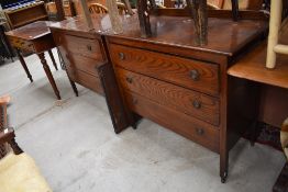 A pair of early 20th Century oak bedroom chests, one having ledge back the other with dressing table