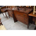 A pair of early 20th Century oak bedroom chests, one having ledge back the other with dressing table